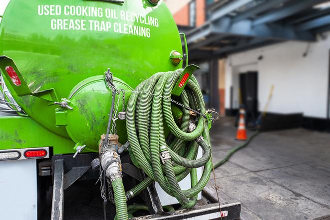 a professional technician pumping a restaurant's grease trap in Ogunquit, ME